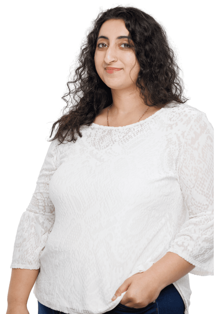 South Asian therapy in Atlanta | muslim female therapist in Atlanta, GA | Women of color therapy in Atlanta | 30263 | 30044 | 30179 South Asian female therapist in Atlanta, Georgia, radiating warmth in a white top and jeans, offering therapeutic services for anxiety and stress management.