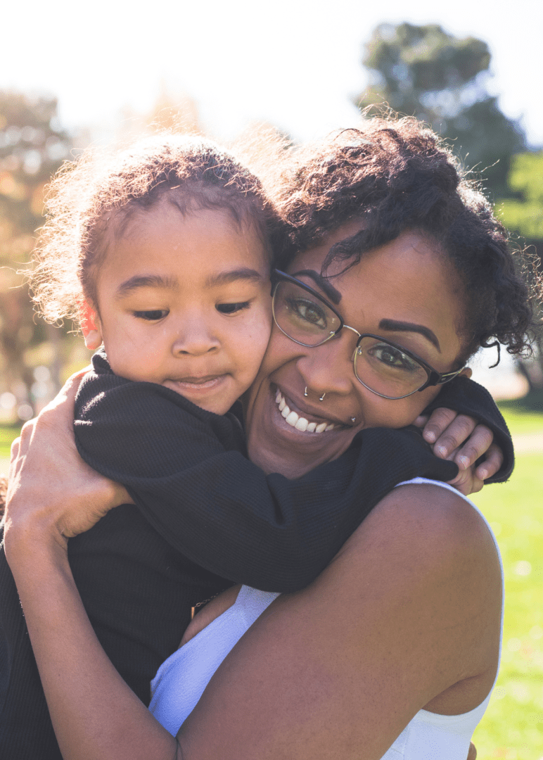 Black mother and son hugging, supporting each other through the stress of family dynamics during the holidays