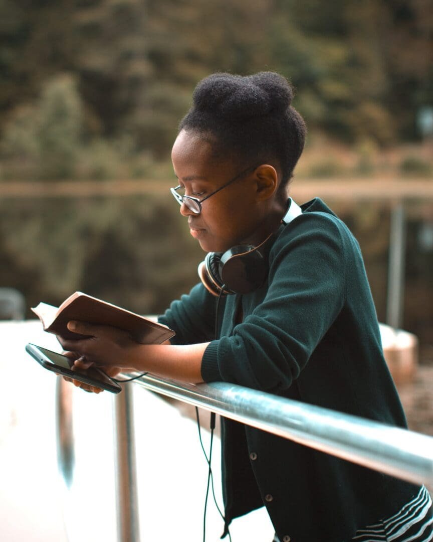 Image of a woman reading a book outside. Showing something that can provide anxiety help. Along with anxiety therapy self care can help reduce anxiety symptoms in Atlanta, GA.