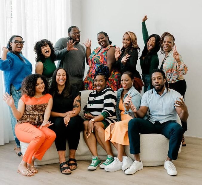 Simplicity Psychotherapy, LLC Eight Black Therapists wearing blue and white posing for photo in natural light. Representing Simplicity Psychotherapy group practice for Black men and women