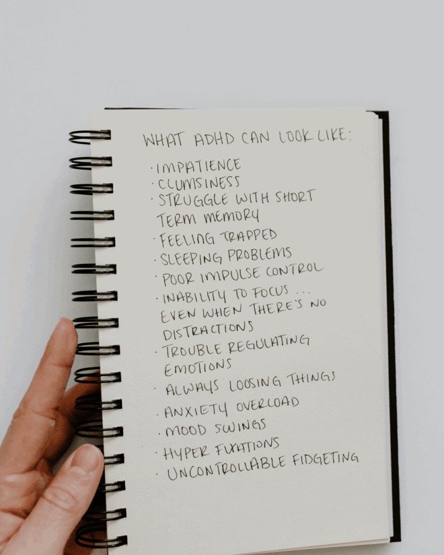 A notebook page lists symptoms such as impatience, poor impulse control, and trouble focusing, highlighting what high-functioning ADHD can look like in daily life.