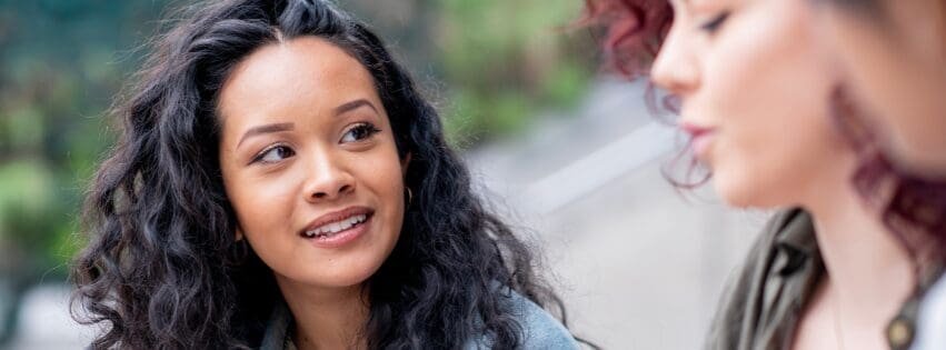 Two women talking, representing therapy for relationship expectations, anxiety, friendships, and emotional communication with an Atlanta therapist.