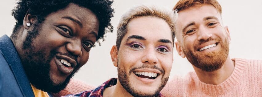 LGBTQ Friends smiling together, representing therapy for relationship expectations, anxiety, and emotional support with an Atlanta therapist.